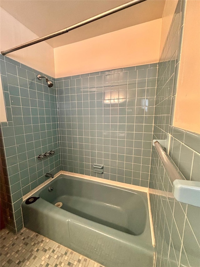 full bath with tile walls, bathing tub / shower combination, and tile patterned floors