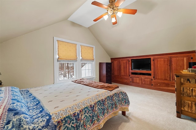 bedroom with ceiling fan, lofted ceiling, and light carpet