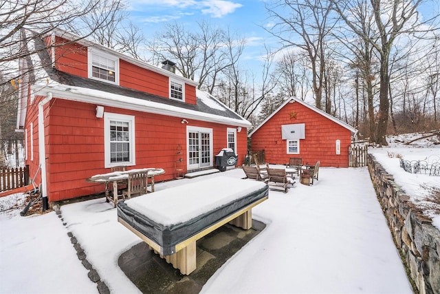 view of snow covered rear of property