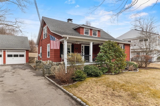 view of front of property with an outbuilding, a porch, a shingled roof, a ceiling fan, and a front lawn