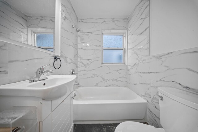 full bathroom featuring vanity, tile walls, toilet, and shower / bath combination