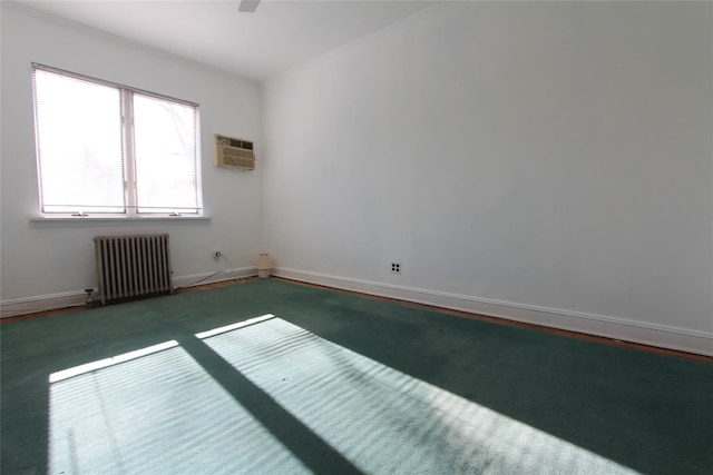 spare room with a wall mounted air conditioner and radiator heating unit