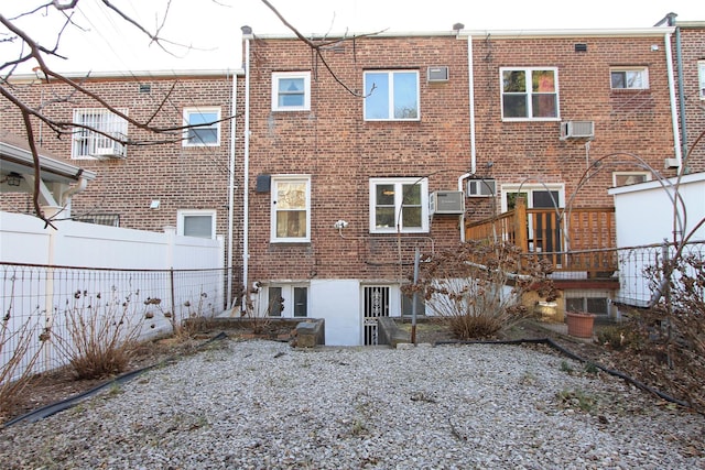 back of house with an AC wall unit