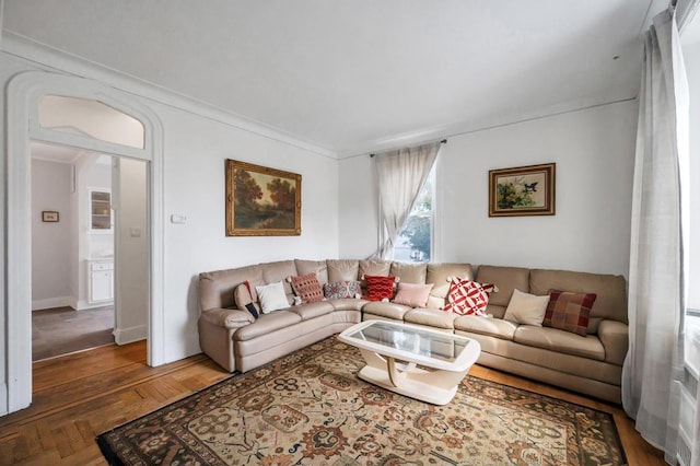 living room featuring ornamental molding and dark wood finished floors