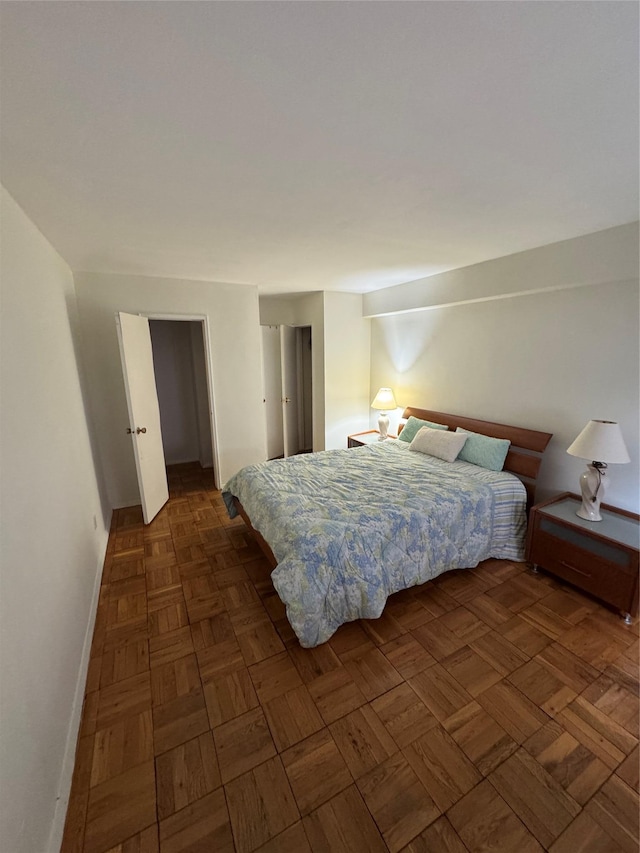 bedroom with dark parquet flooring