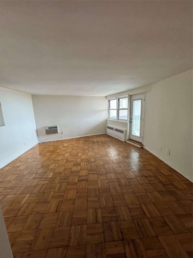 empty room with parquet flooring and radiator