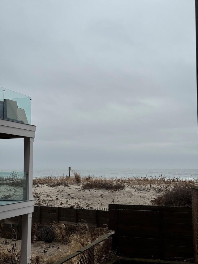 view of yard featuring a beach view and a water view