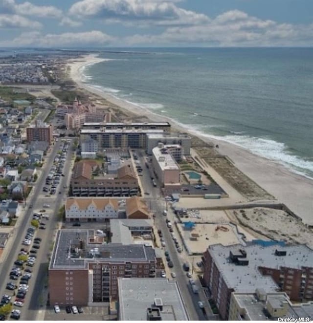 aerial view with a water view and a beach view