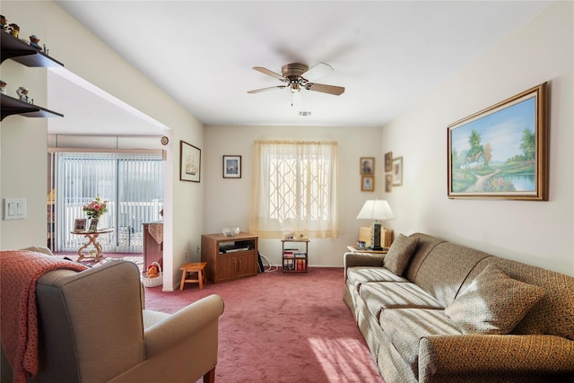 carpeted living area with visible vents, a ceiling fan, and a wealth of natural light