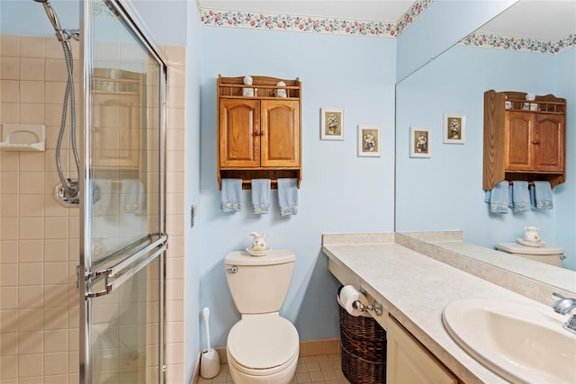 full bathroom with vanity, a shower stall, toilet, and baseboards