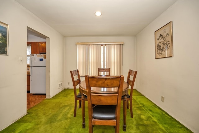 dining space featuring parquet floors