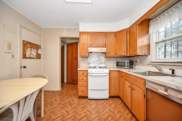 kitchen featuring dishwashing machine, sink, light parquet floors, white range with gas stovetop, and tasteful backsplash