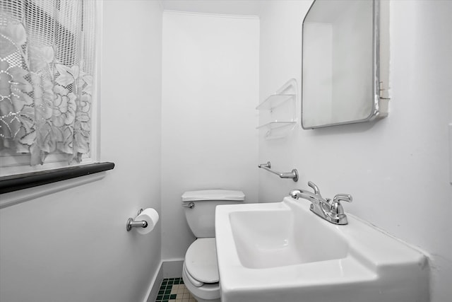 bathroom featuring sink, tile patterned floors, and toilet