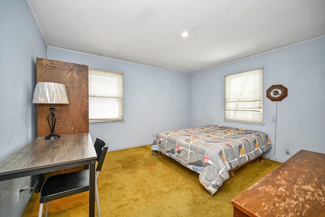 bedroom with multiple windows and carpet floors