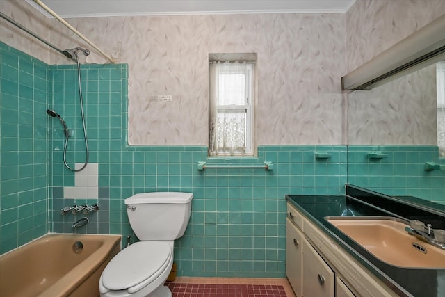 full bathroom featuring crown molding, vanity, tiled shower / bath, tile patterned floors, and toilet