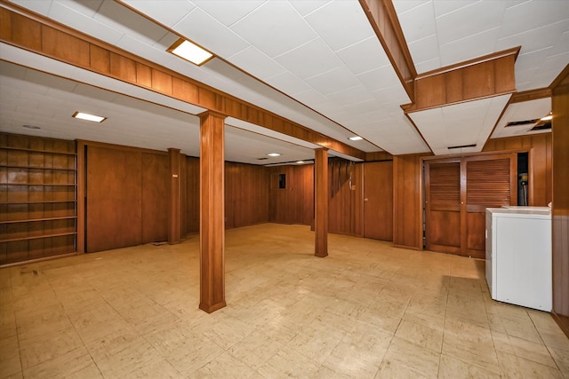 basement featuring washer / clothes dryer and wood walls