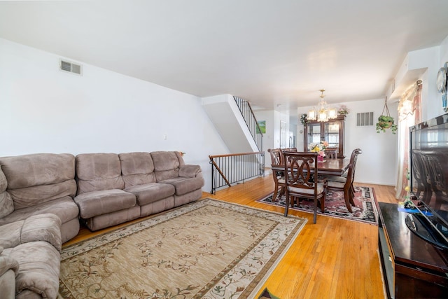 living room with hardwood / wood-style flooring and a chandelier