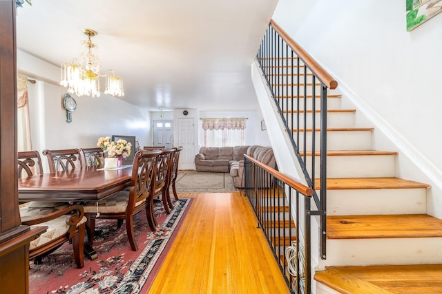 dining space with wood-type flooring and a chandelier