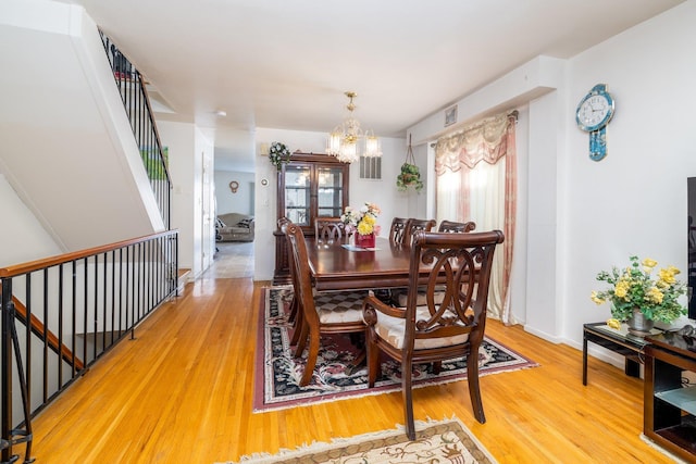 dining room featuring hardwood / wood-style flooring and a chandelier