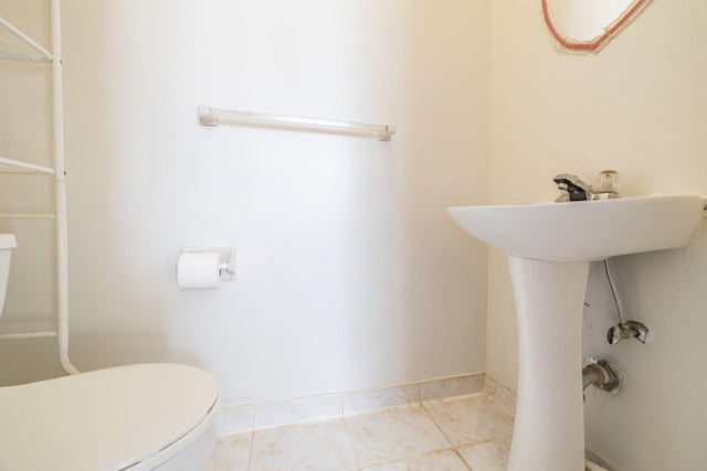 bathroom featuring tile patterned flooring and toilet