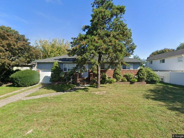 view of front of home featuring a garage and a front lawn