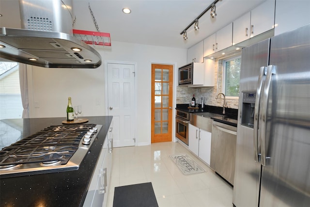 kitchen with tasteful backsplash, white cabinets, appliances with stainless steel finishes, and island range hood