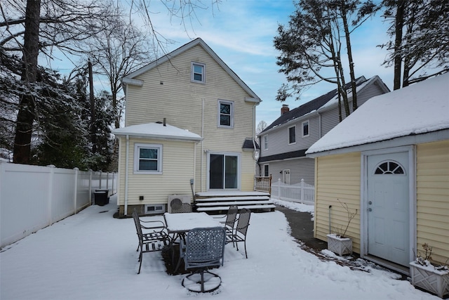 view of snow covered back of property