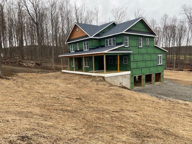 view of front of property featuring a garage and a porch