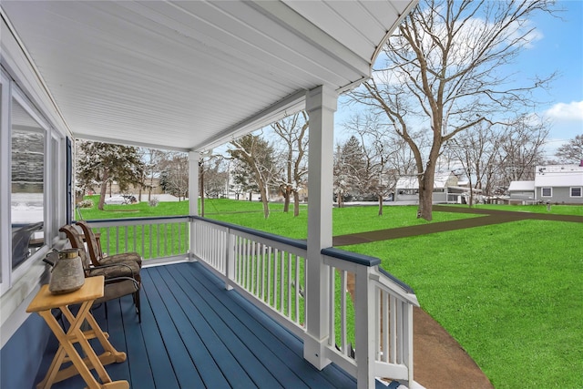 wooden deck with a yard and covered porch