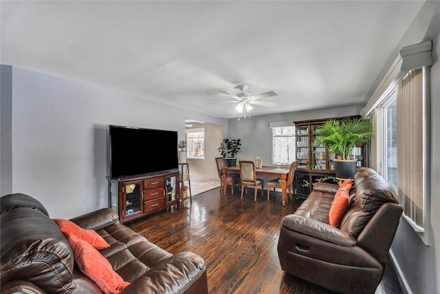 living room featuring ceiling fan and dark hardwood / wood-style flooring