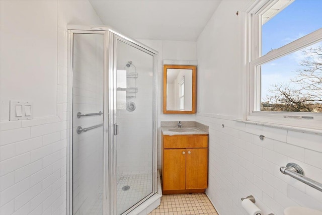 313 Sixth Ave, Pelham, NY 10803 - bathroom with tile walls, an enclosed shower, vanity, and tile patterned floors