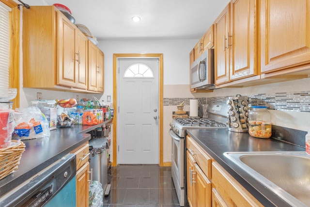 11122 114th St, South Ozone Park, NY 11420 - kitchen with tasteful backsplash, sink, stainless steel appliances, and dark tile patterned floors