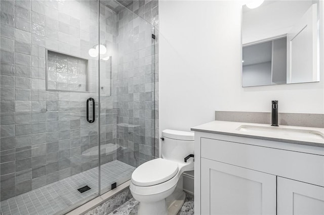 full bath featuring toilet, a stall shower, and vanity