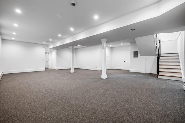 finished basement featuring baseboards, stairs, visible vents, and recessed lighting