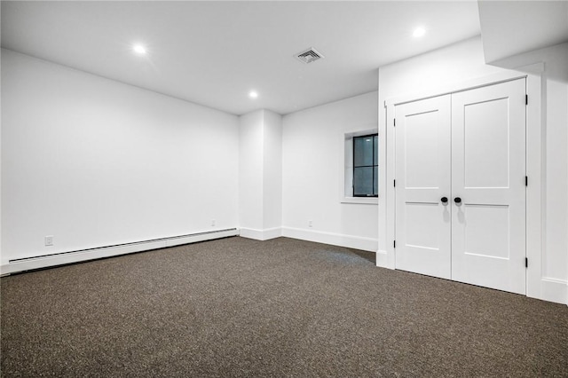 spare room featuring recessed lighting, visible vents, dark carpet, baseboard heating, and baseboards