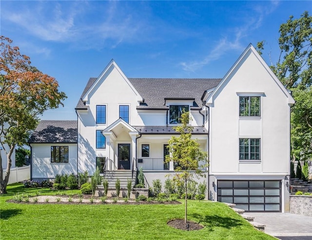 modern farmhouse style home with roof with shingles, a standing seam roof, a garage, driveway, and a front lawn