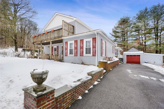 view of front of property with a garage and an outdoor structure