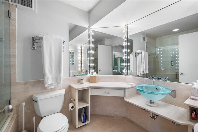 bathroom featuring toilet, walk in shower, tile walls, tile patterned floors, and vanity