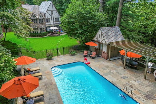 view of pool with a patio, fence, a fenced in pool, an outdoor structure, and a lawn