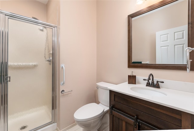 bathroom with toilet, vanity, and a shower with door