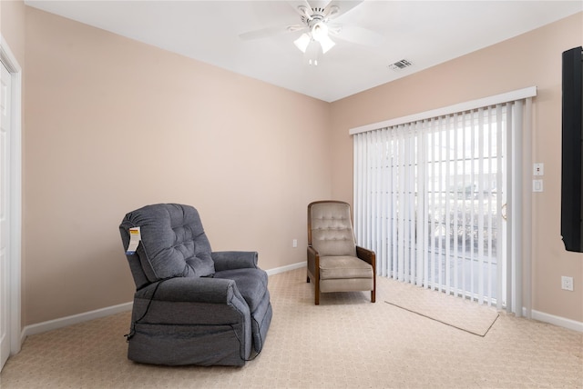 living area featuring ceiling fan and carpet floors