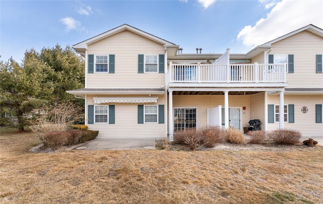 view of front facade with a front yard and a patio