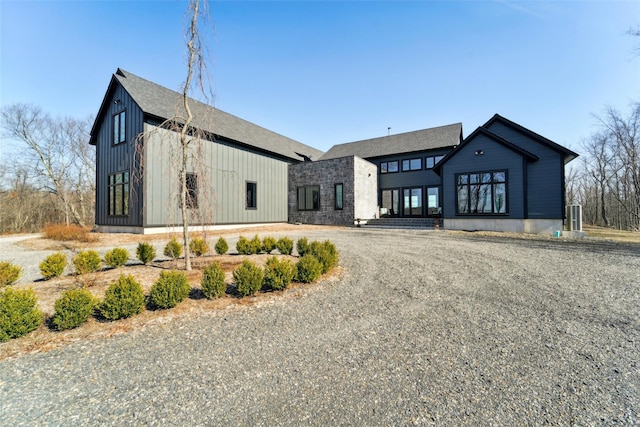 modern farmhouse featuring driveway and board and batten siding