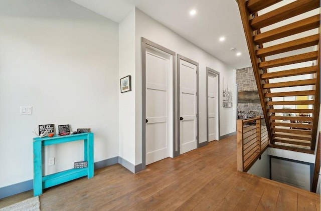 interior space featuring baseboards, wood finished floors, and recessed lighting