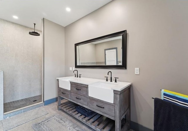 full bath with double vanity, a sink, recessed lighting, and a walk in shower