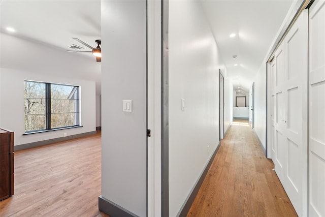 corridor with visible vents, baseboards, recessed lighting, and light wood-type flooring