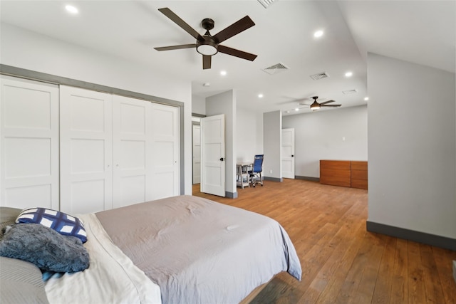 bedroom featuring visible vents, a closet, recessed lighting, and hardwood / wood-style floors