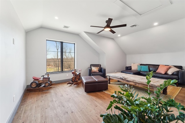 living area featuring lofted ceiling, ceiling fan, visible vents, and wood finished floors