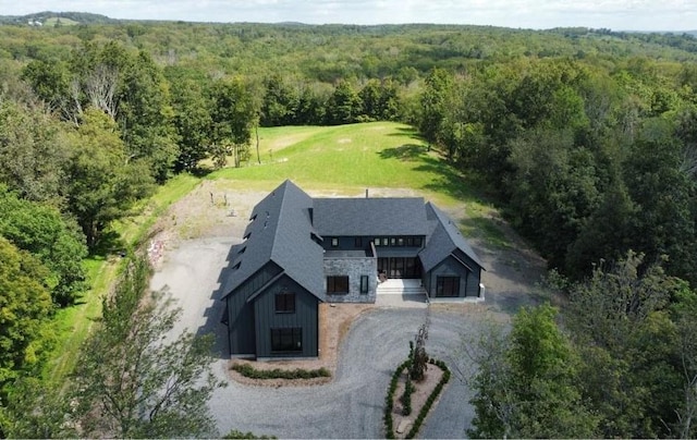 drone / aerial view with a wooded view