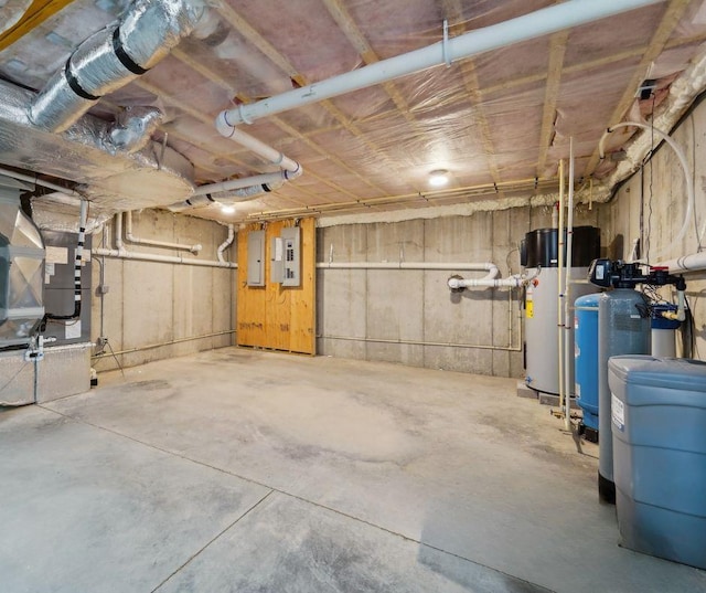 unfinished below grade area with water heater, heating unit, and electric panel